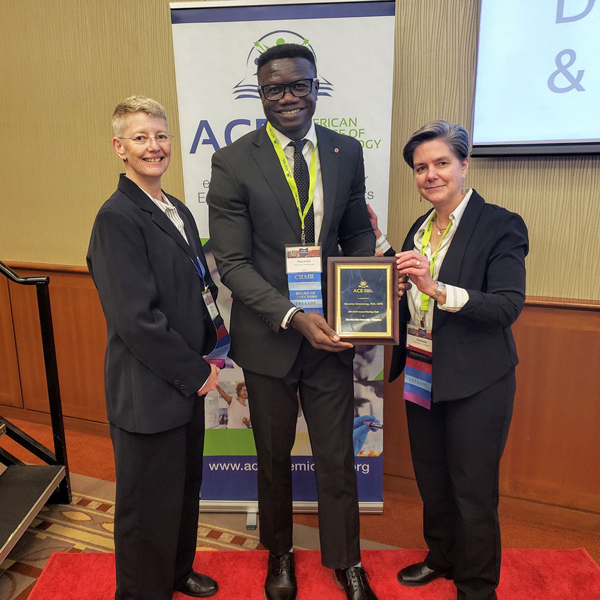 macarius donneyong holding plaque with two people