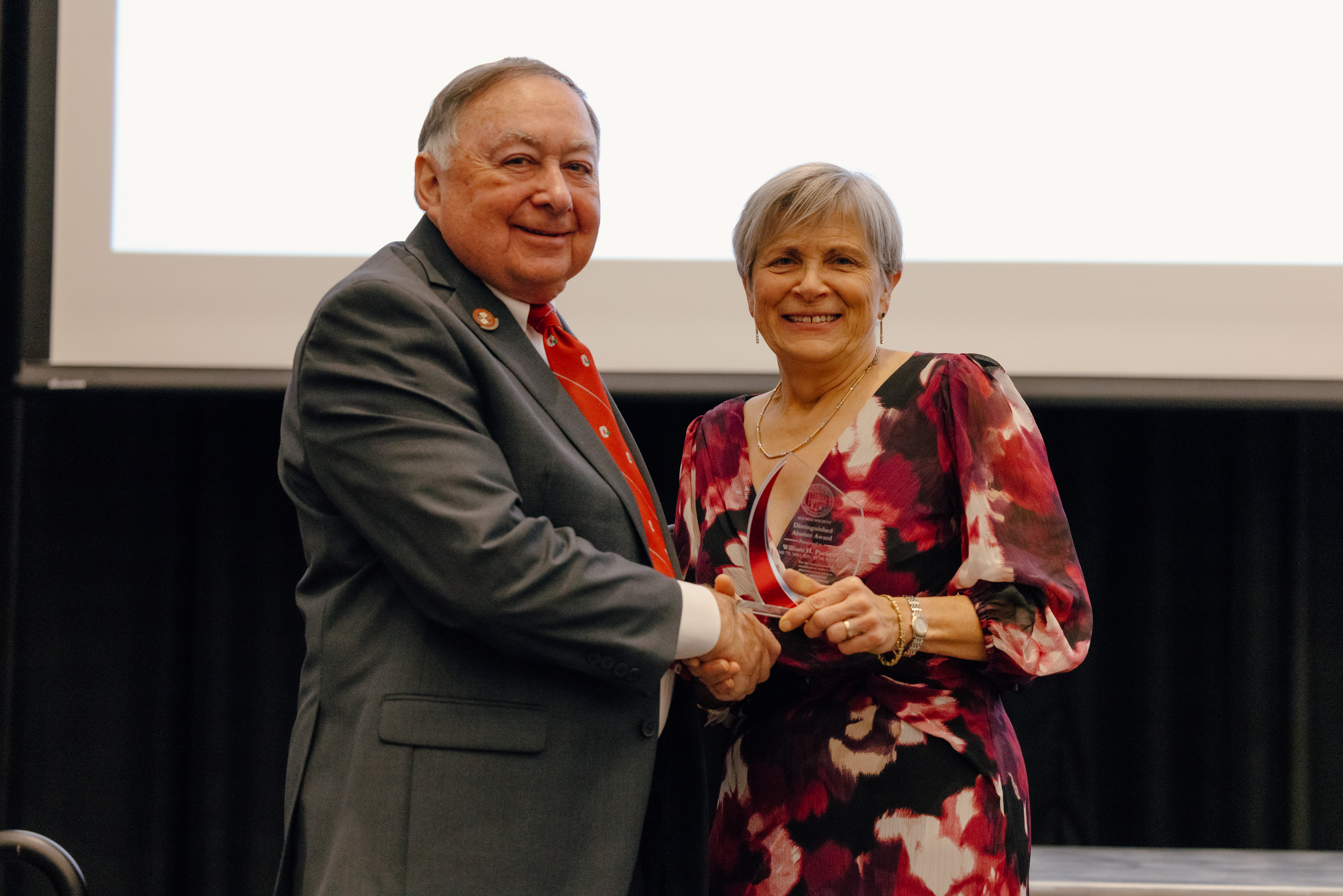 Dr. Puckett and Dean Deanna Kroetz presenting the Distinguished Alumni Award