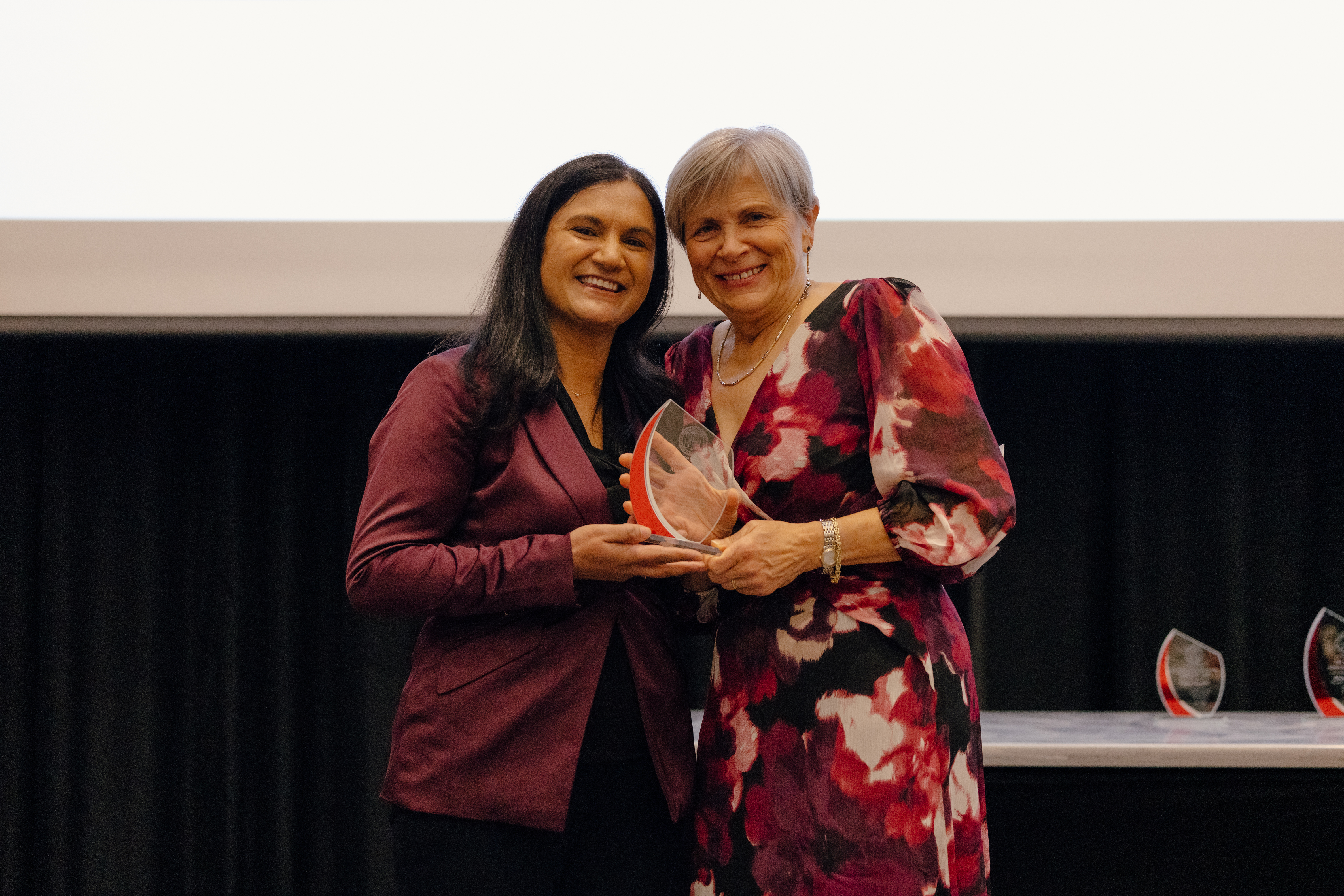 Dr. Vishalpura and Dean Deanna Kroetz presenting the Distinguished Alumni Award