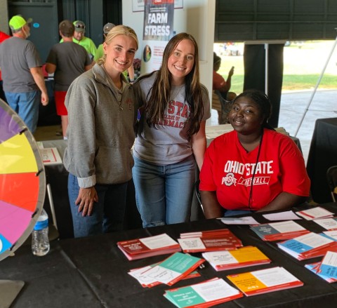 Students at the College of Pharmacy table