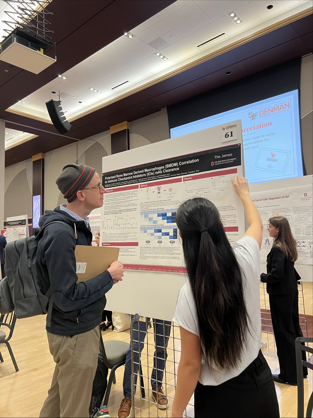 Reviewer and student in front of presentation.