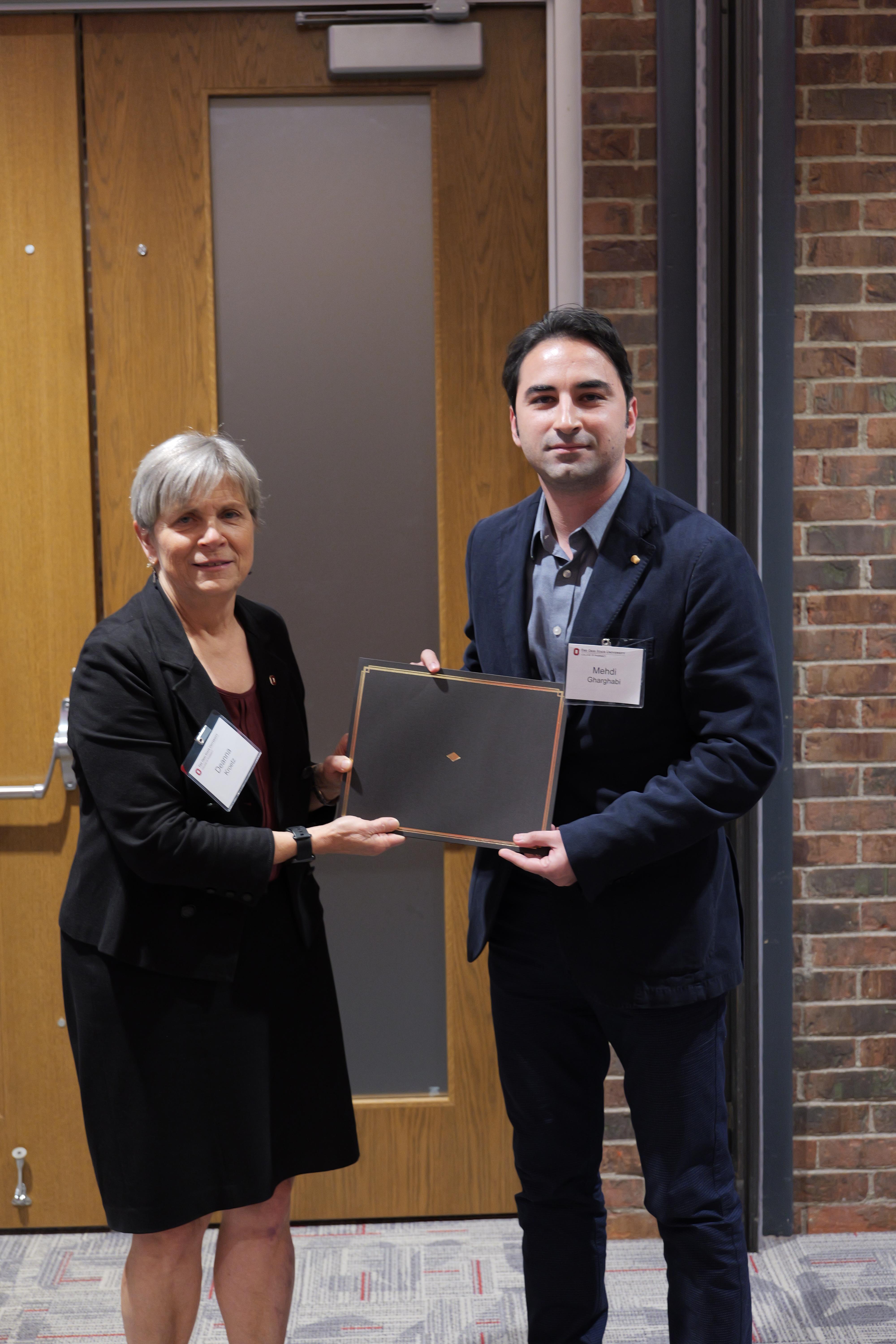 Mehdi Gharghabi with Dean Kroetz accepting award