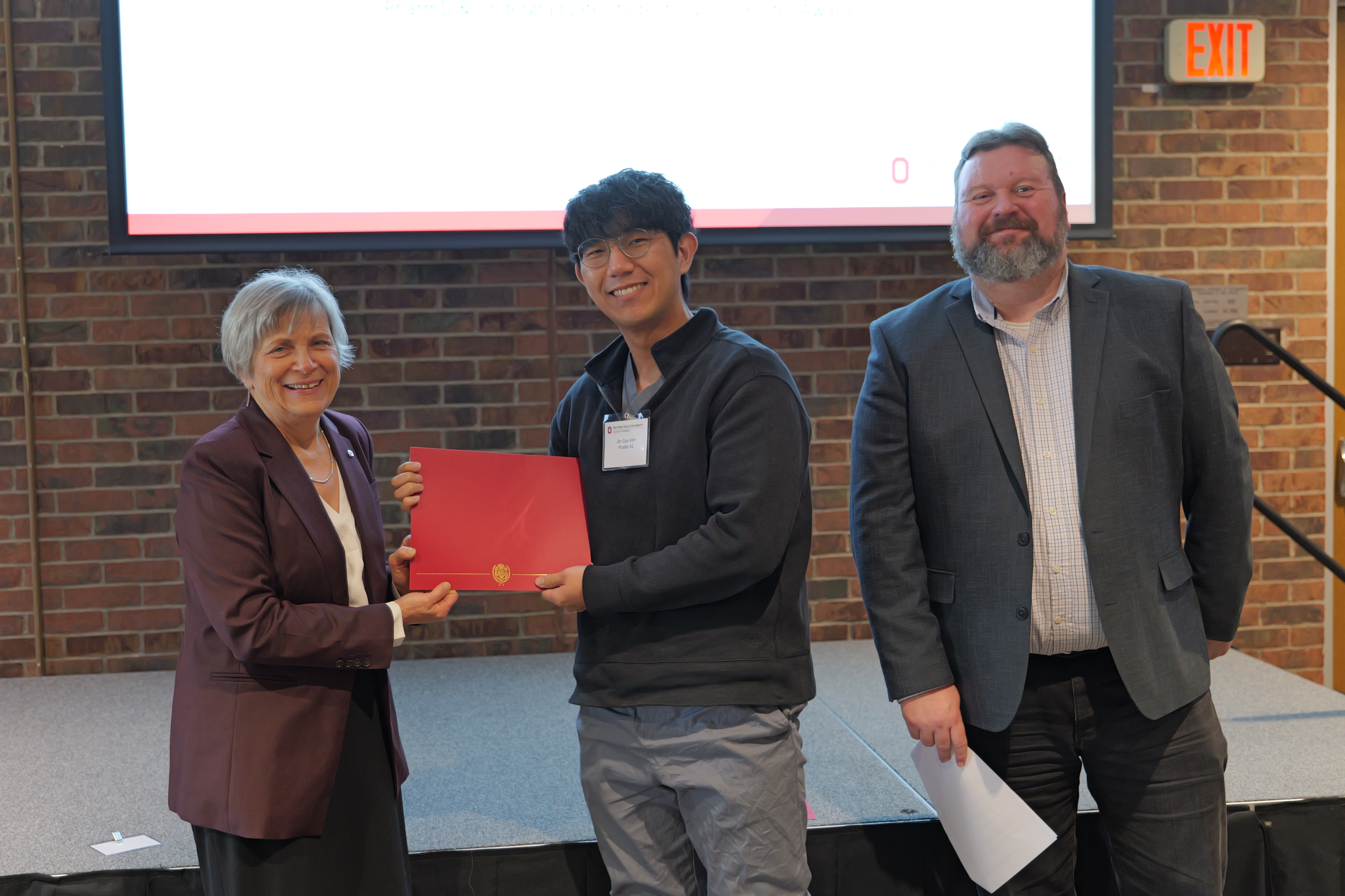 Jin Gyu Kim holding his certificate 
