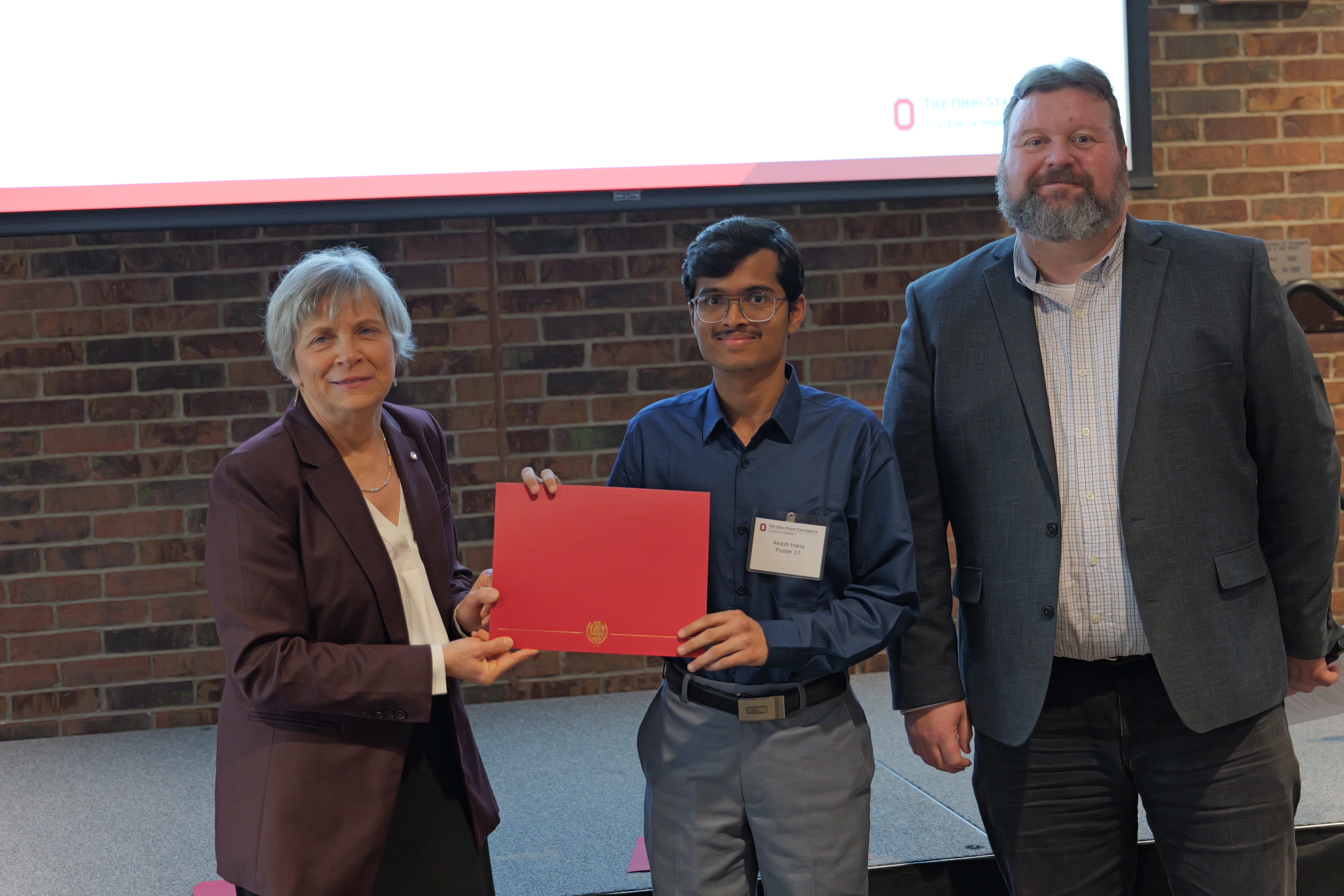 Akash holding his certificate 