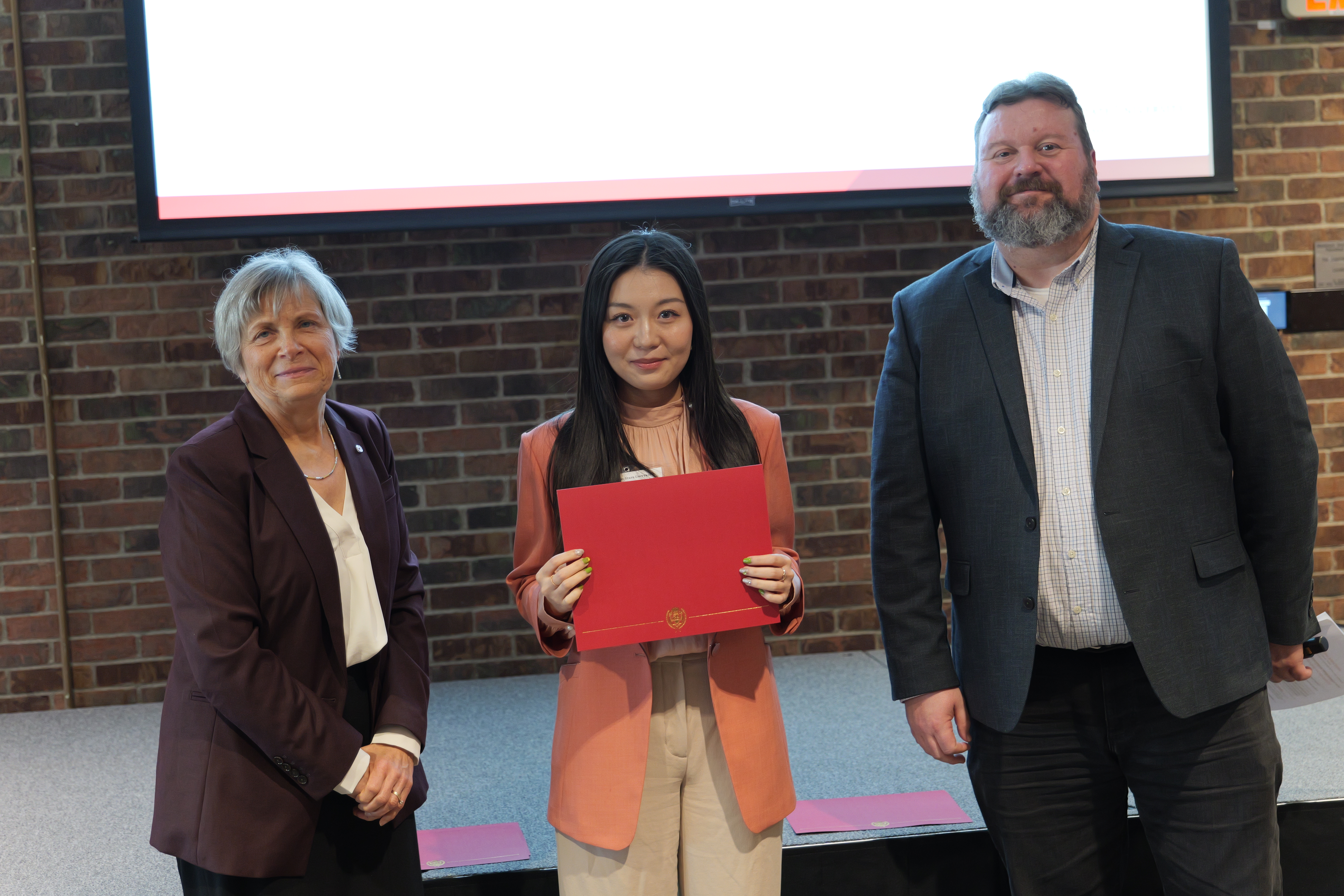 Xinyu holding her certificate 