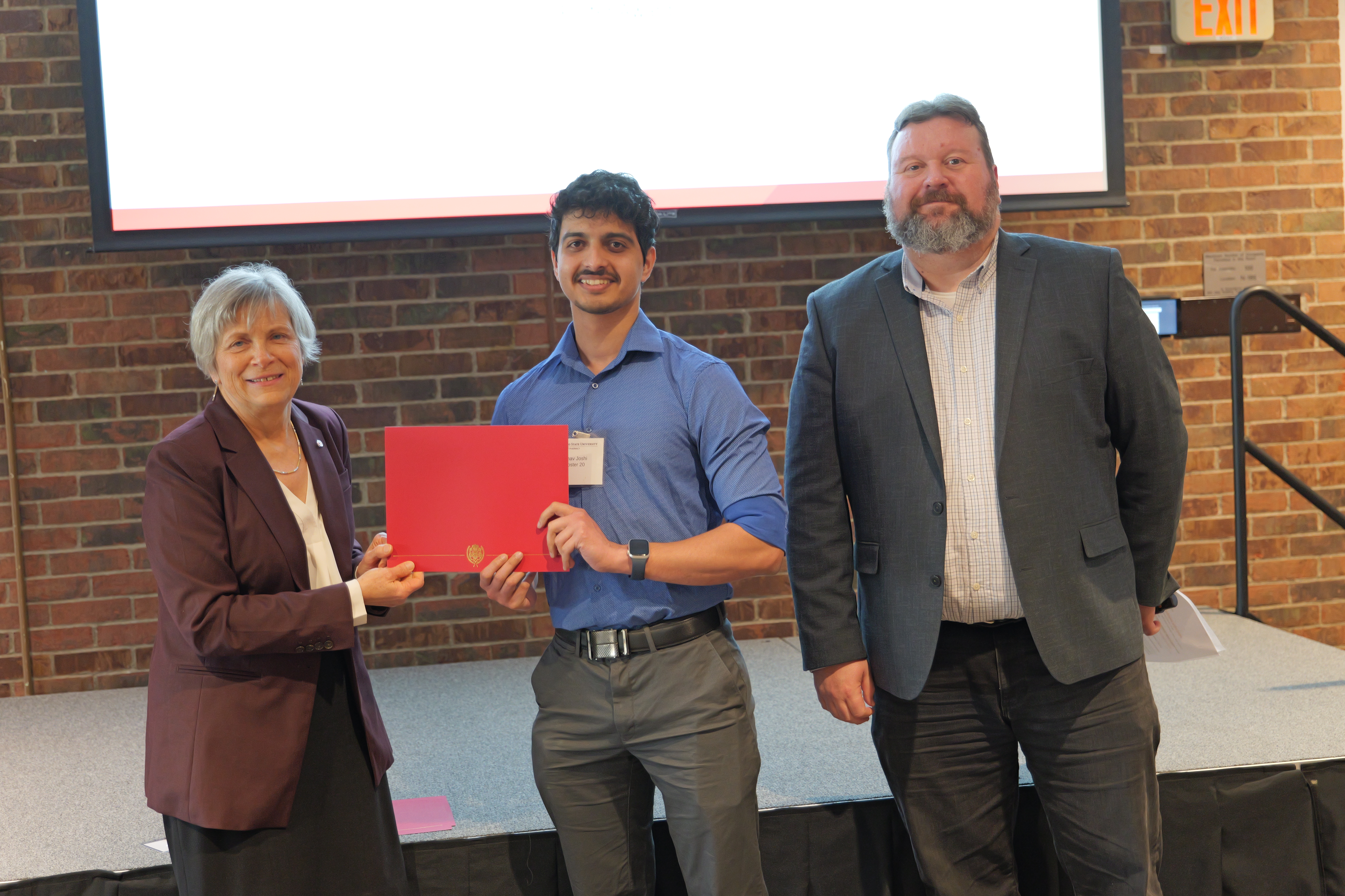 Arnav holding his certificate 