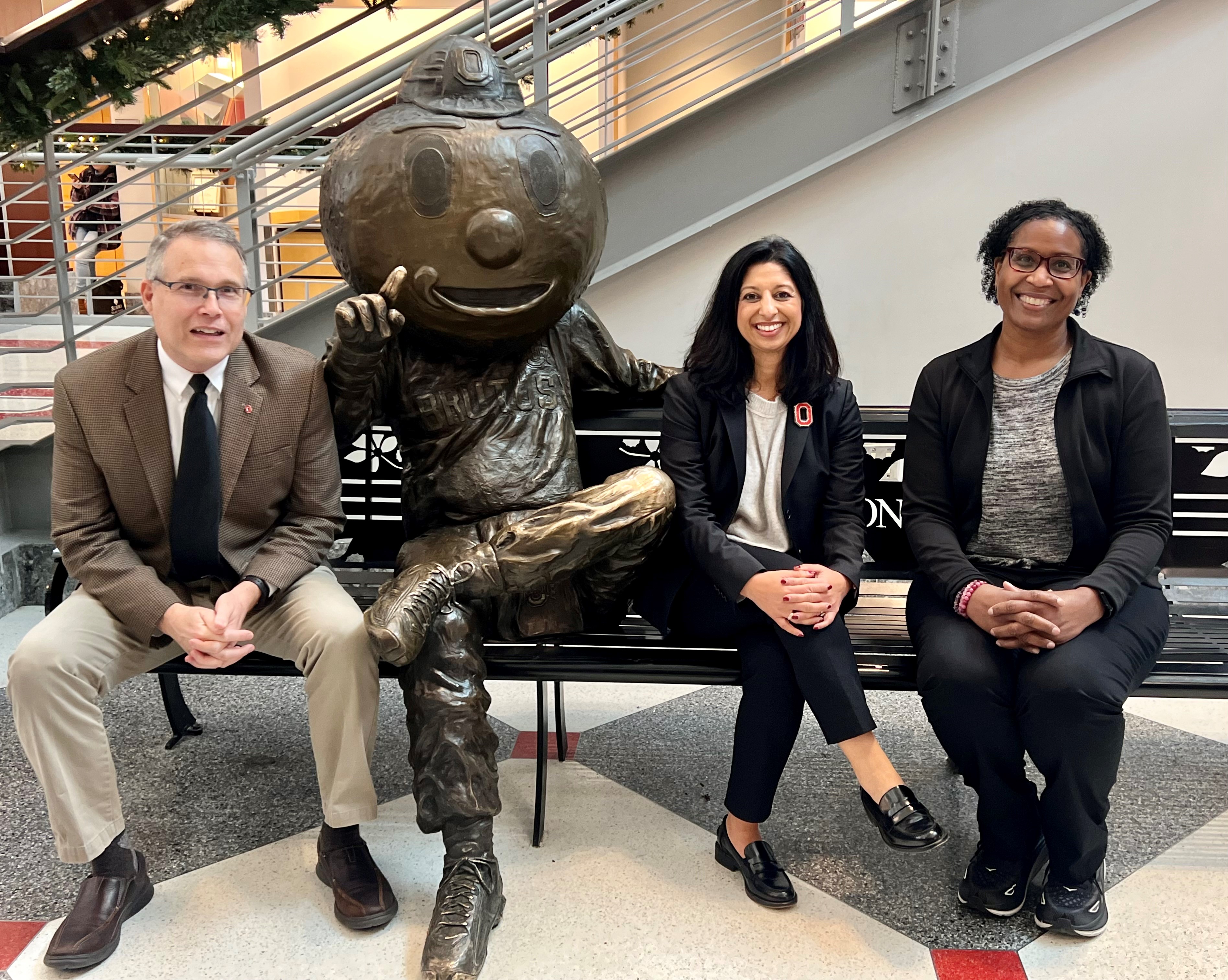 dr mcauley, broze brutus statue, dr mehta, ms henderson on a bench