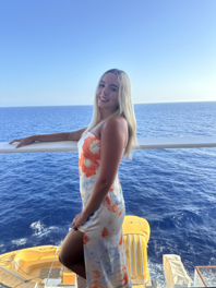 a person posting in front of an ocean