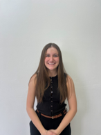 a person posing in front of a wall