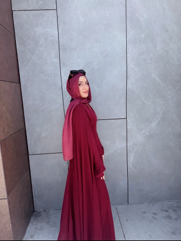 a person posing in front of a wall