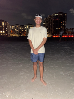 a person posing on a beach at night