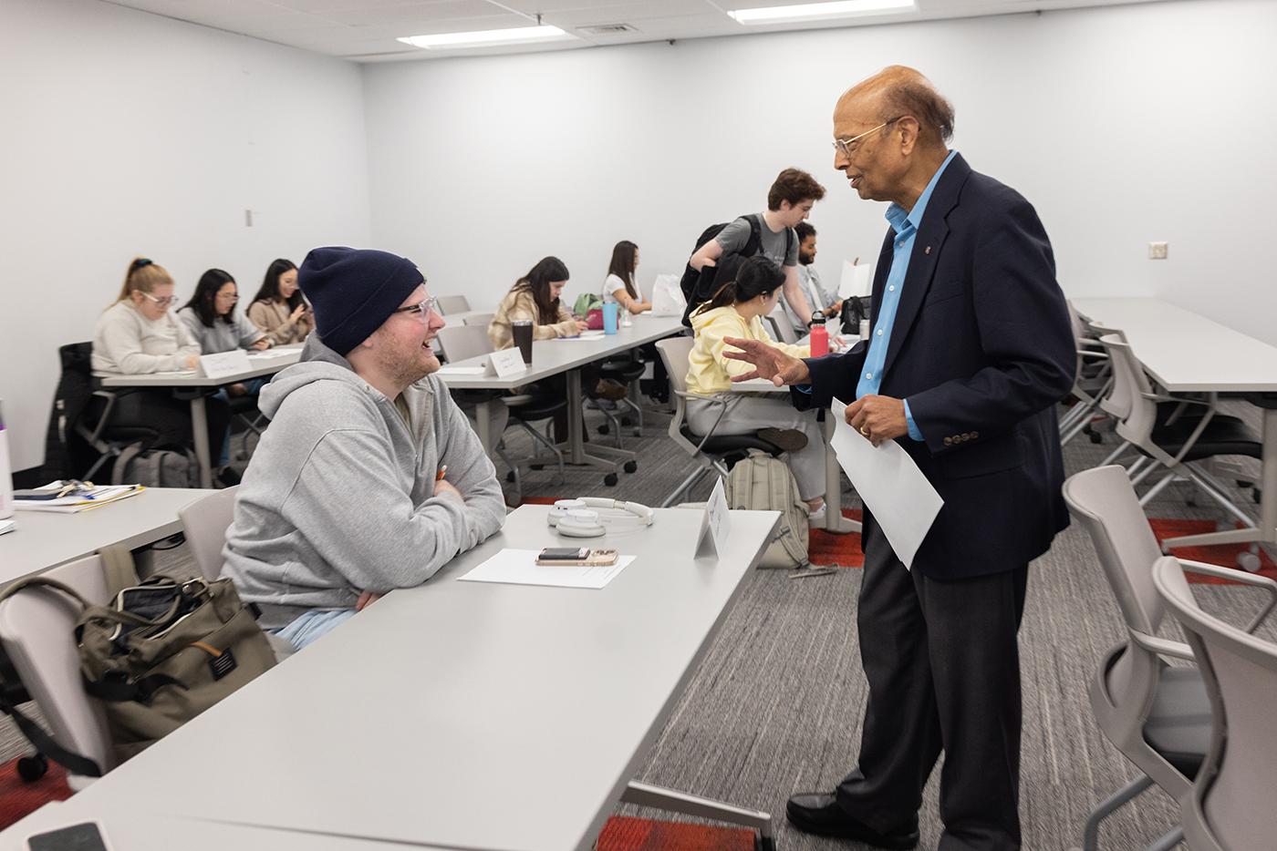 Dr. Nahata speaking with a PharmD student in the classroom