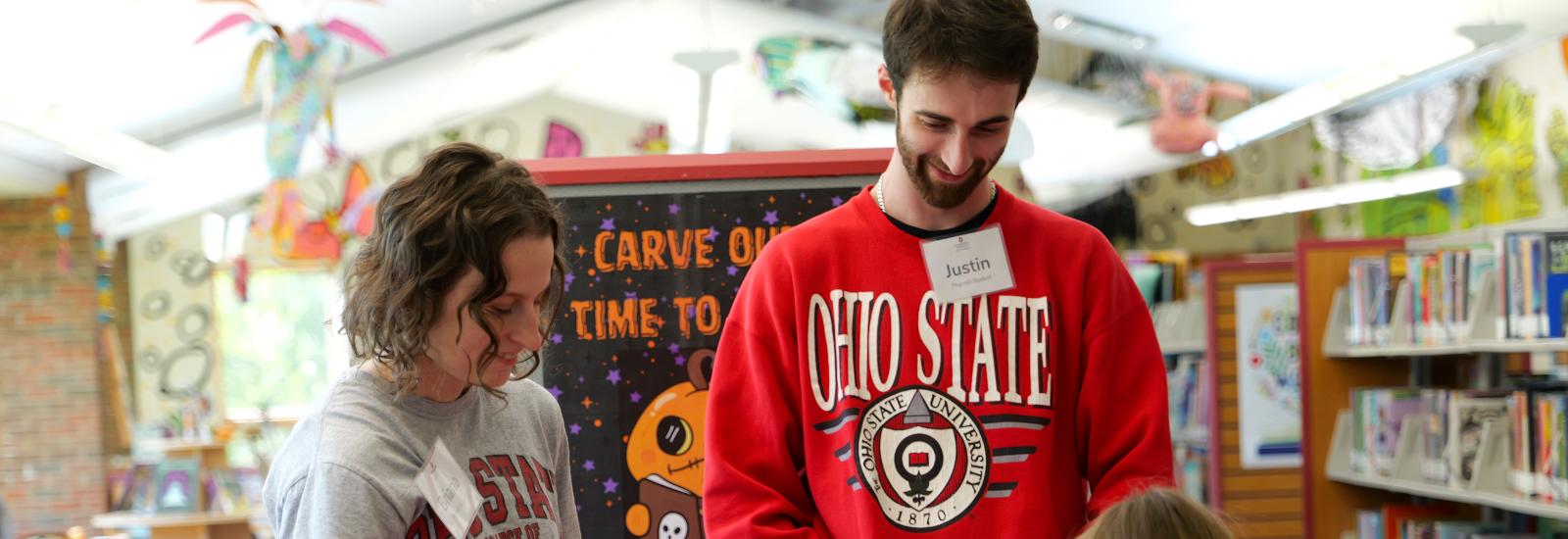 PharmD students lead a library patron through a vaccine-learning game at Athens Public Library