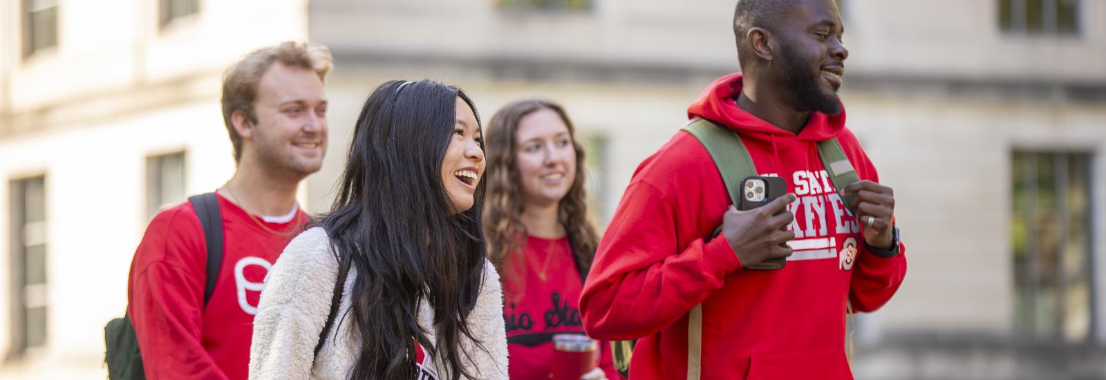 a group of four students walking outside