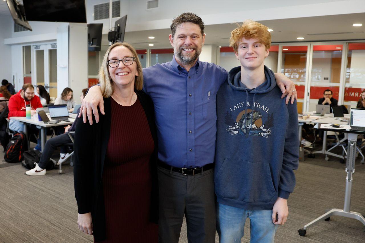 three people posing for a photo