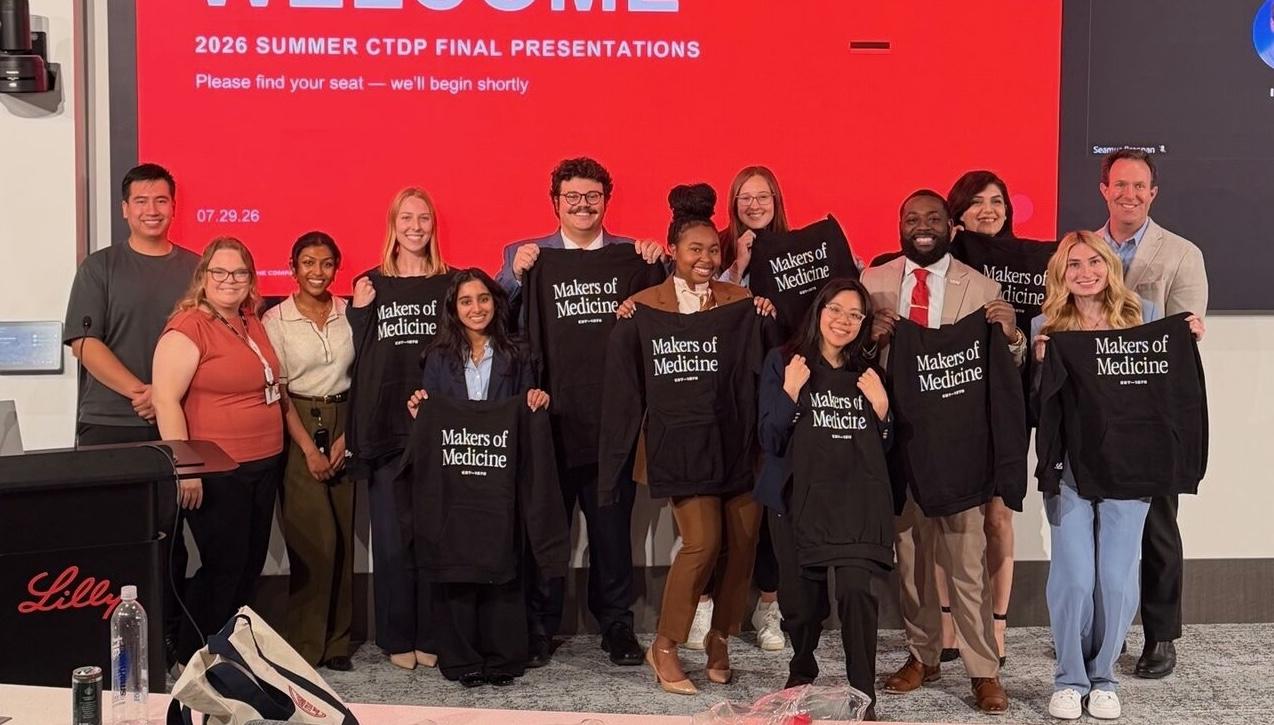 Student group posing with "Makers of Medicine" internship shirts