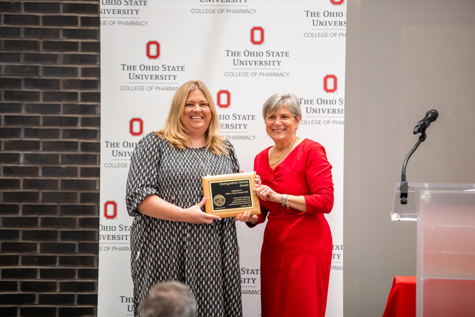 Kelly accepting award from Dean Kroetz