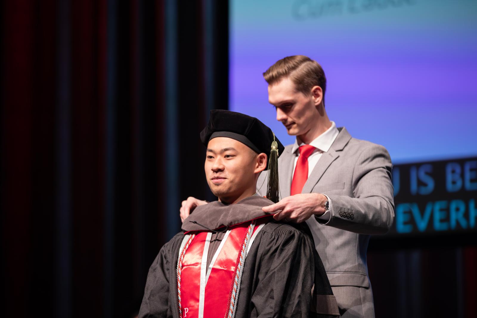 Christian Hu being hooded