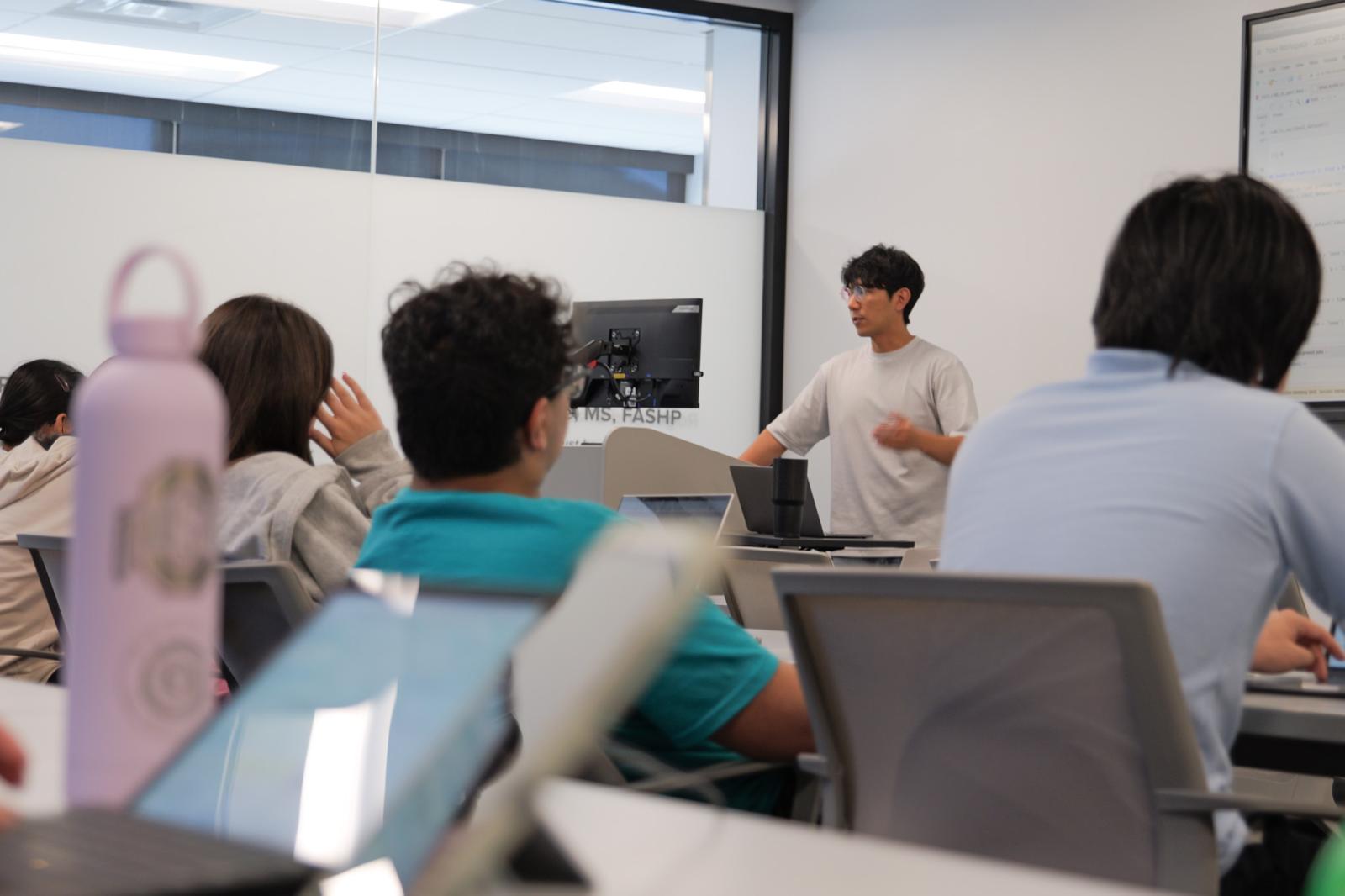 Dr. Kim speaking to a class full of students