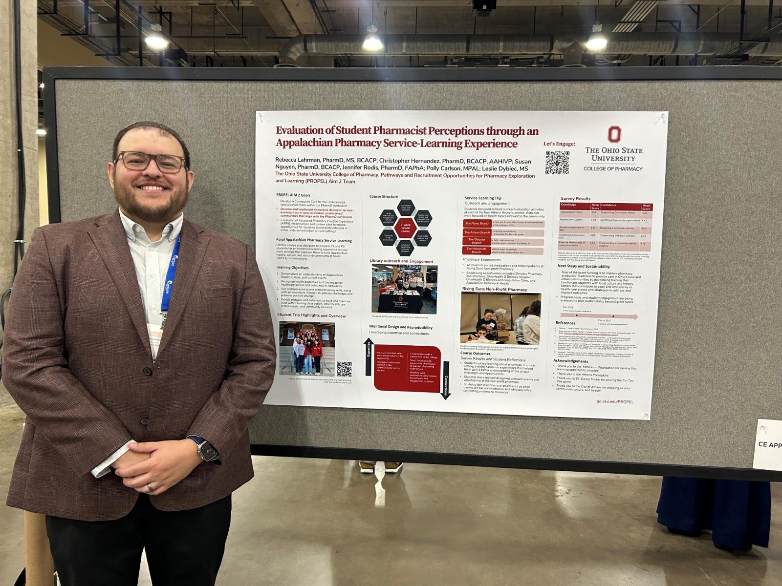 Dr. Hernandez in front of his poster presentation.