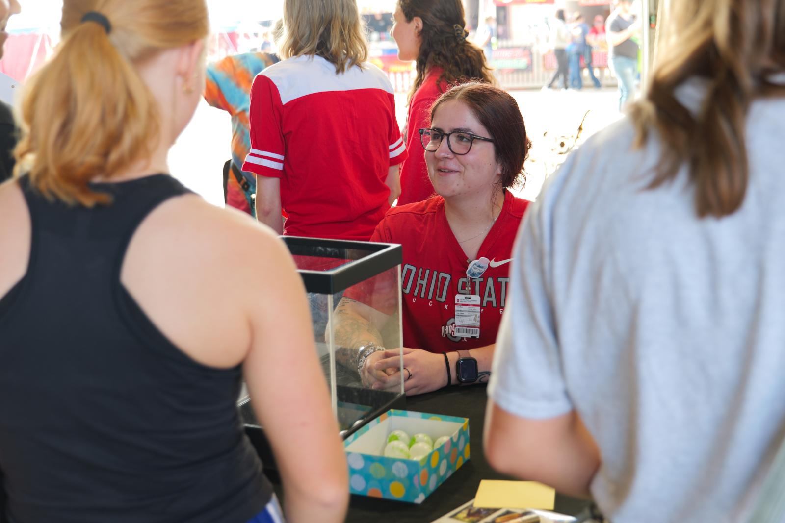 PharmD student leading the vaccine education game at the College of Pharmacy's vaccine education table