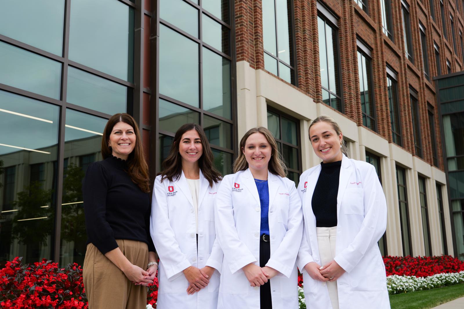 Dr. Higginbotham (left) with former GIM residents and mentees