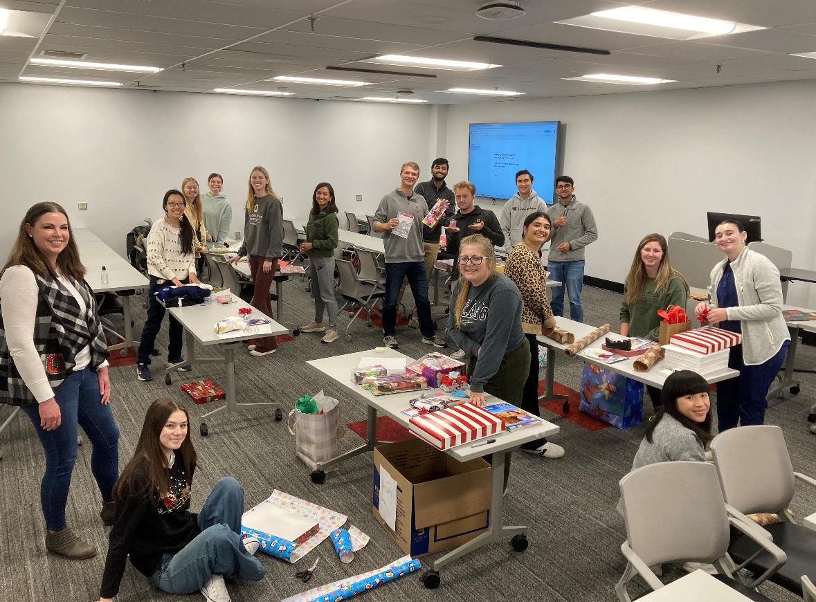 students in a classroom packing gifts