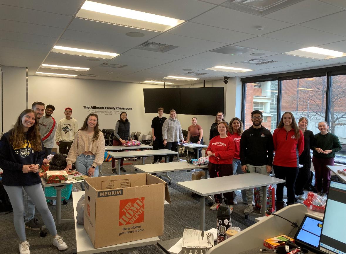 students in a classroom packing gifts