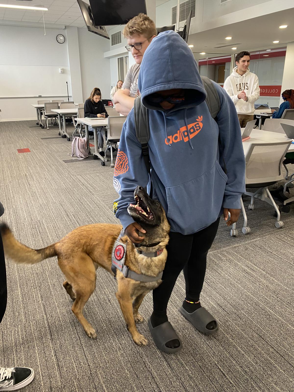 student petting a dog