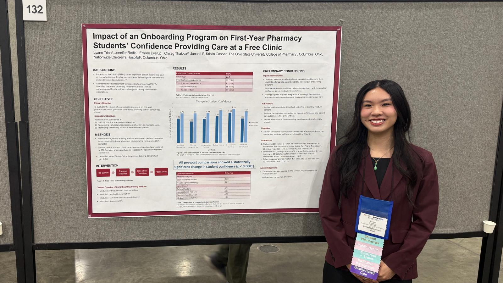 Lyann Trinh in front of her poster 