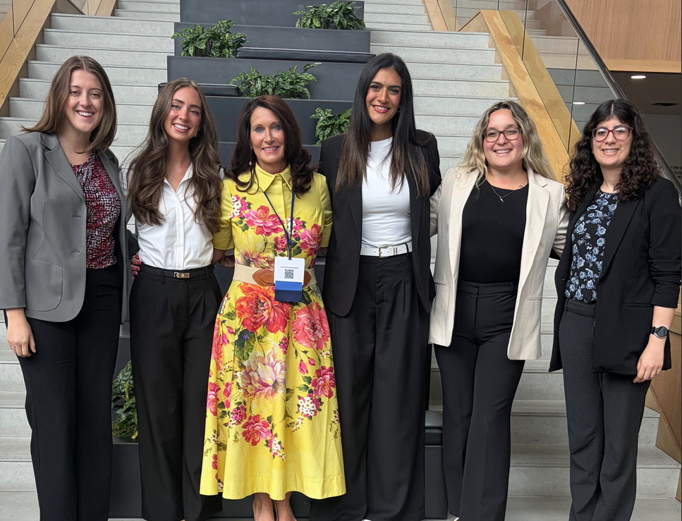 Six women standing in front of concrete steps