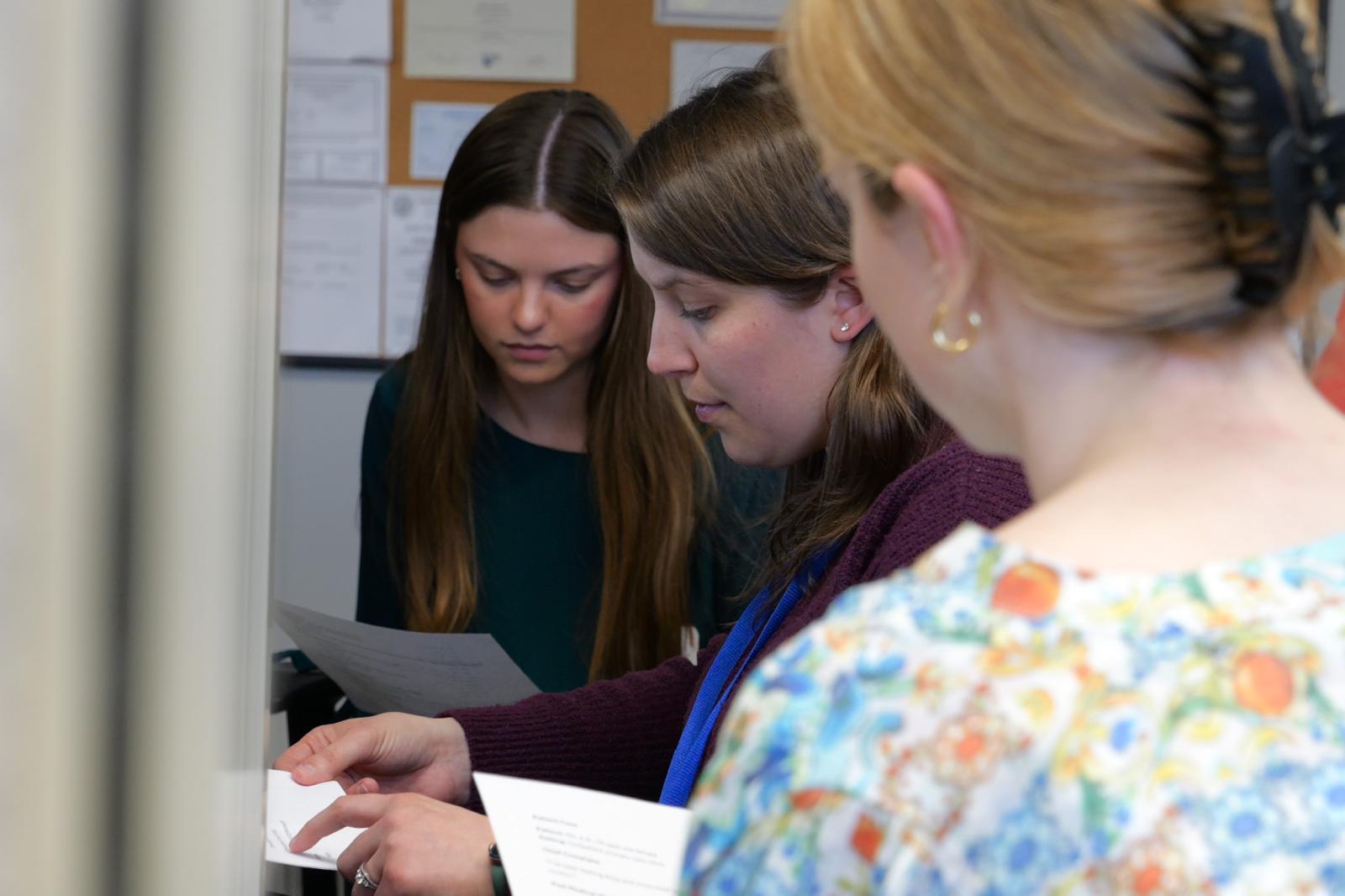 Students sitting with pharmacist preceptor