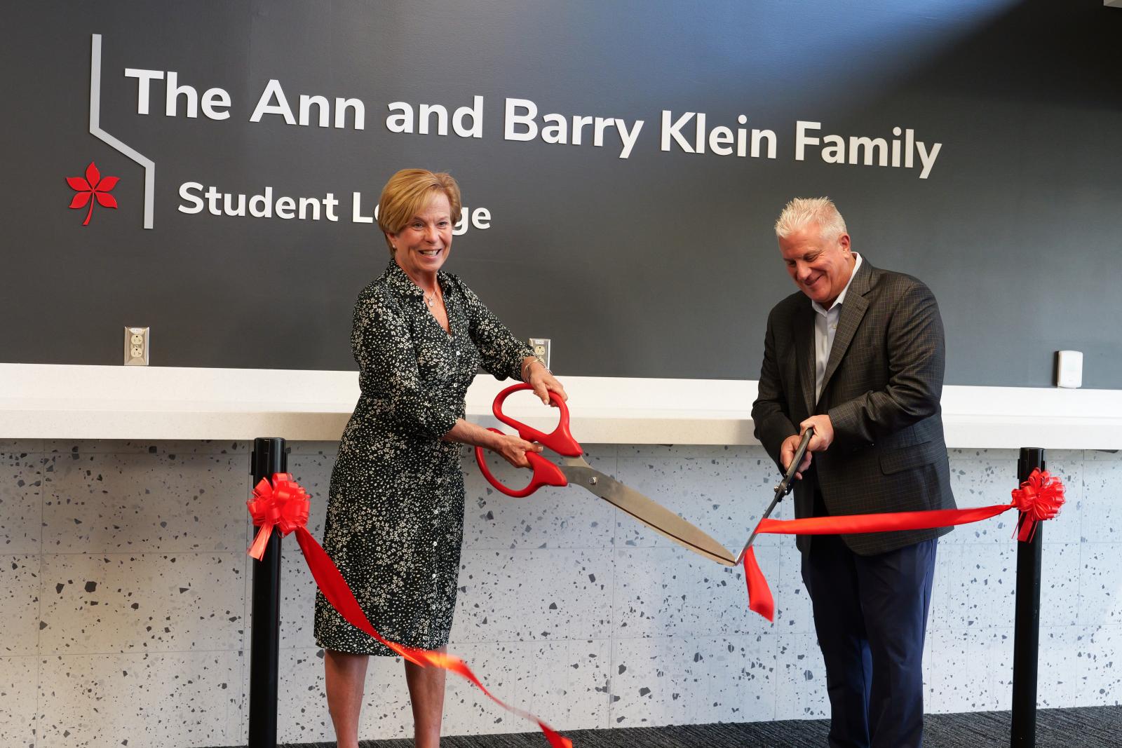 Barry and Ann Klein cutting the red ribbon. 