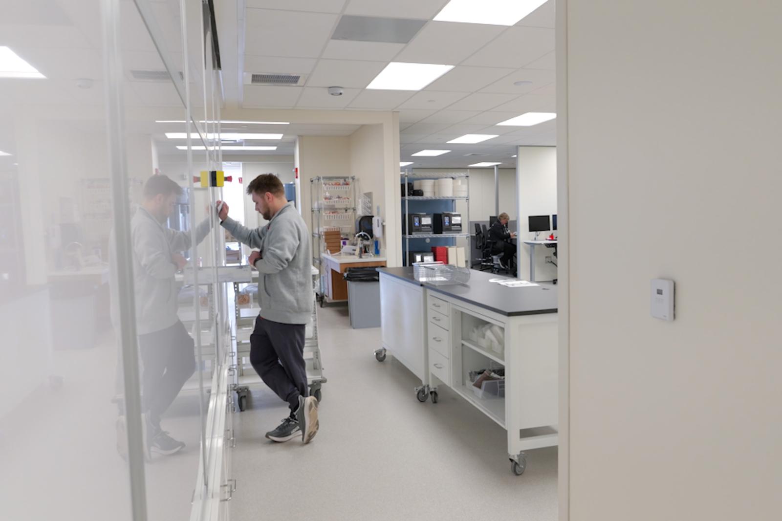 Dr. Schmiesing working with automated medication dispensing in University Hospital's inpatient pharmacy