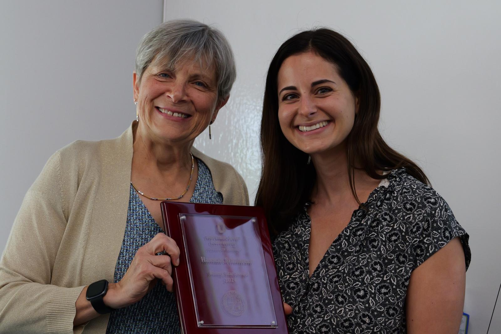 Hannah Schulman and Dean Kroetz posing with plaque