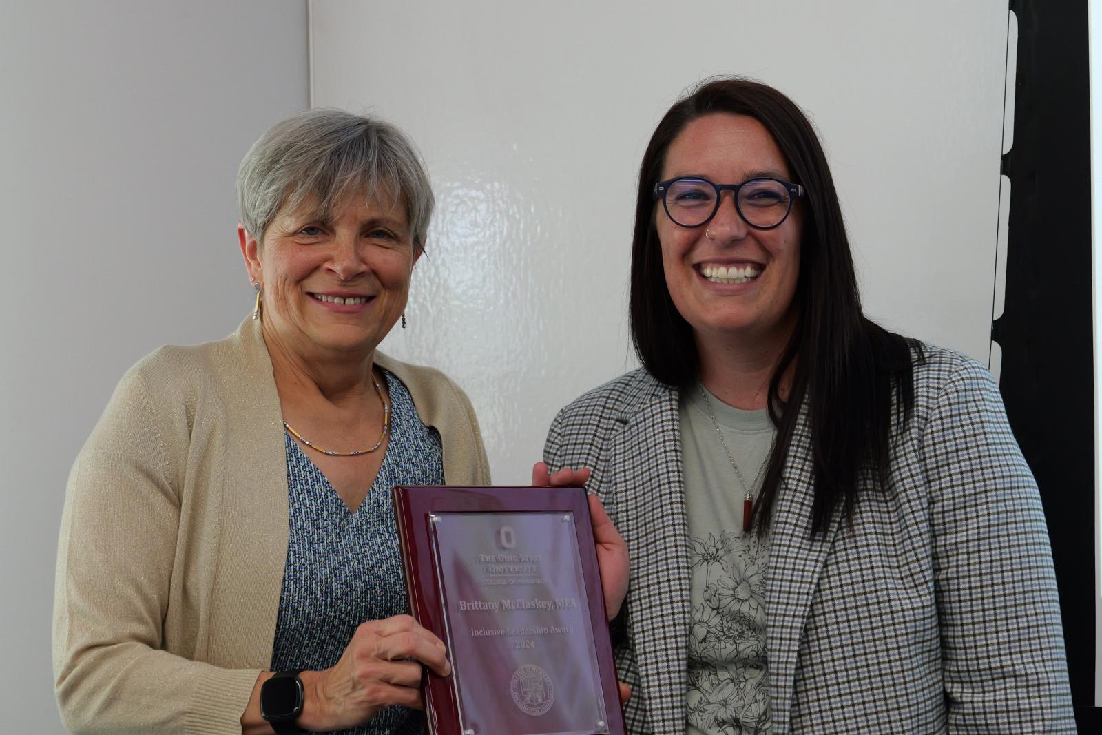 Brittany McClaskey and Dean Kroetz posing with plaque