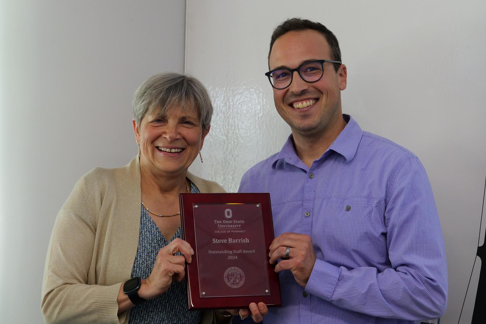 Steve Barrish and Dean Kroetz posing with award plaque