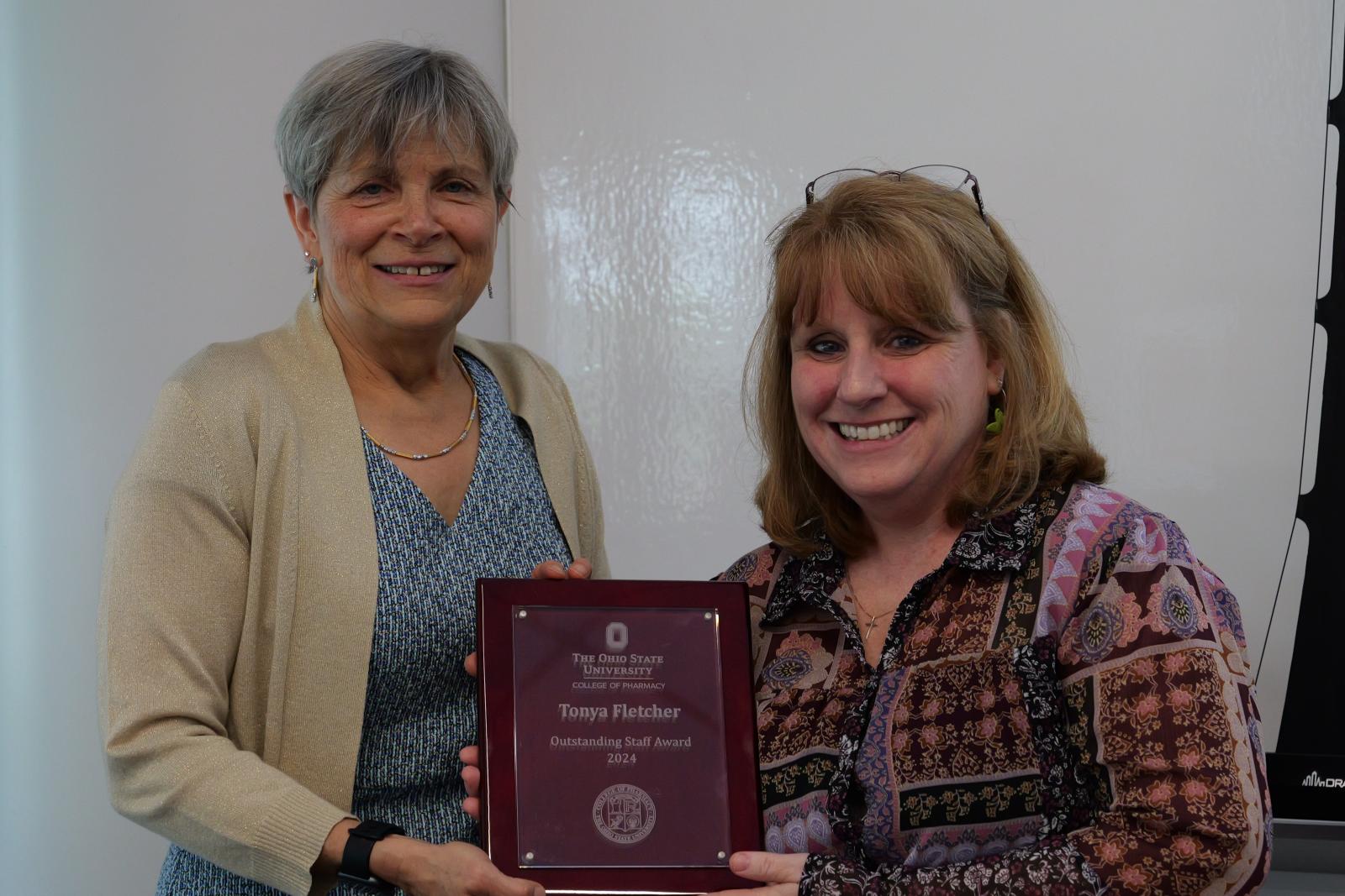 Tonya Fletcher and Dean Kroetz posing with plaque