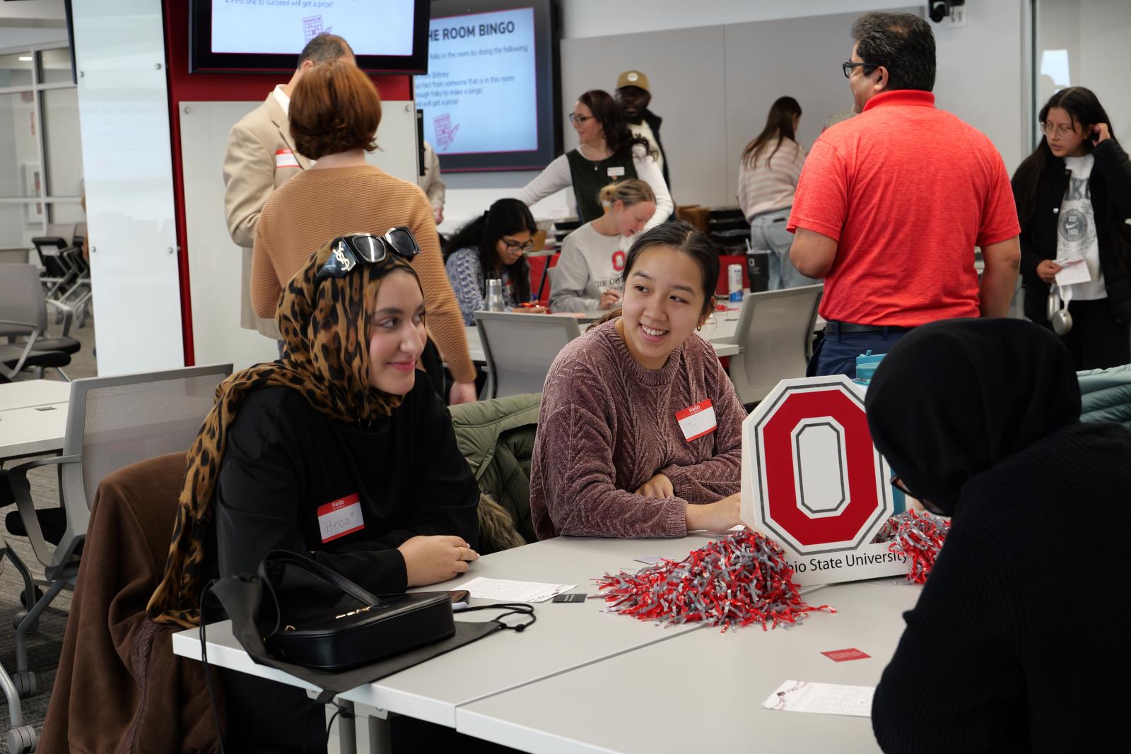 Two individuals smiling at one another.