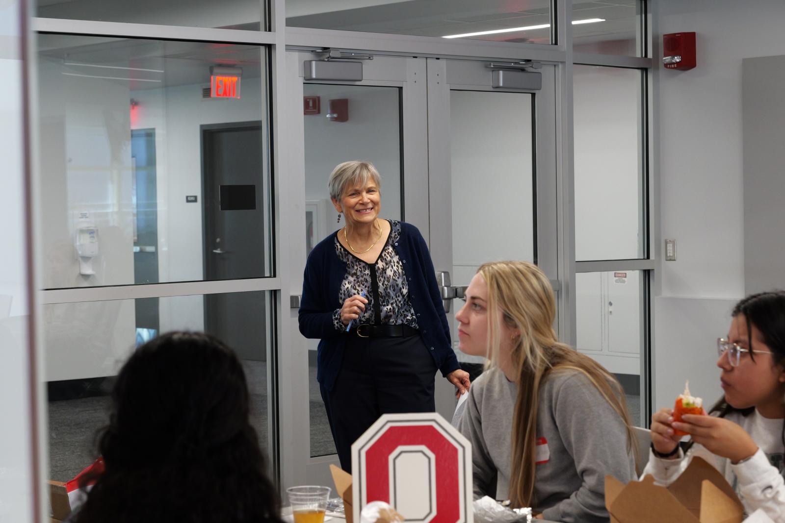 Dean Kroetz smiling to a group of people. 