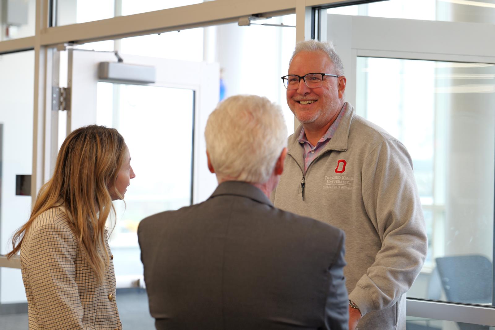 Dr. Weber talking to two people