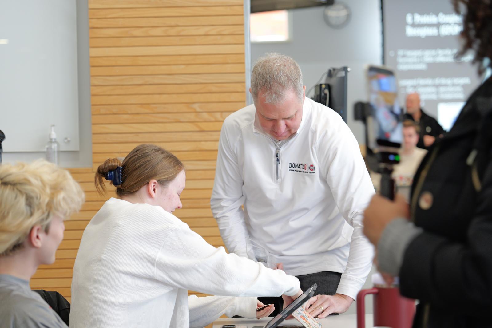 Kevin handing out coins