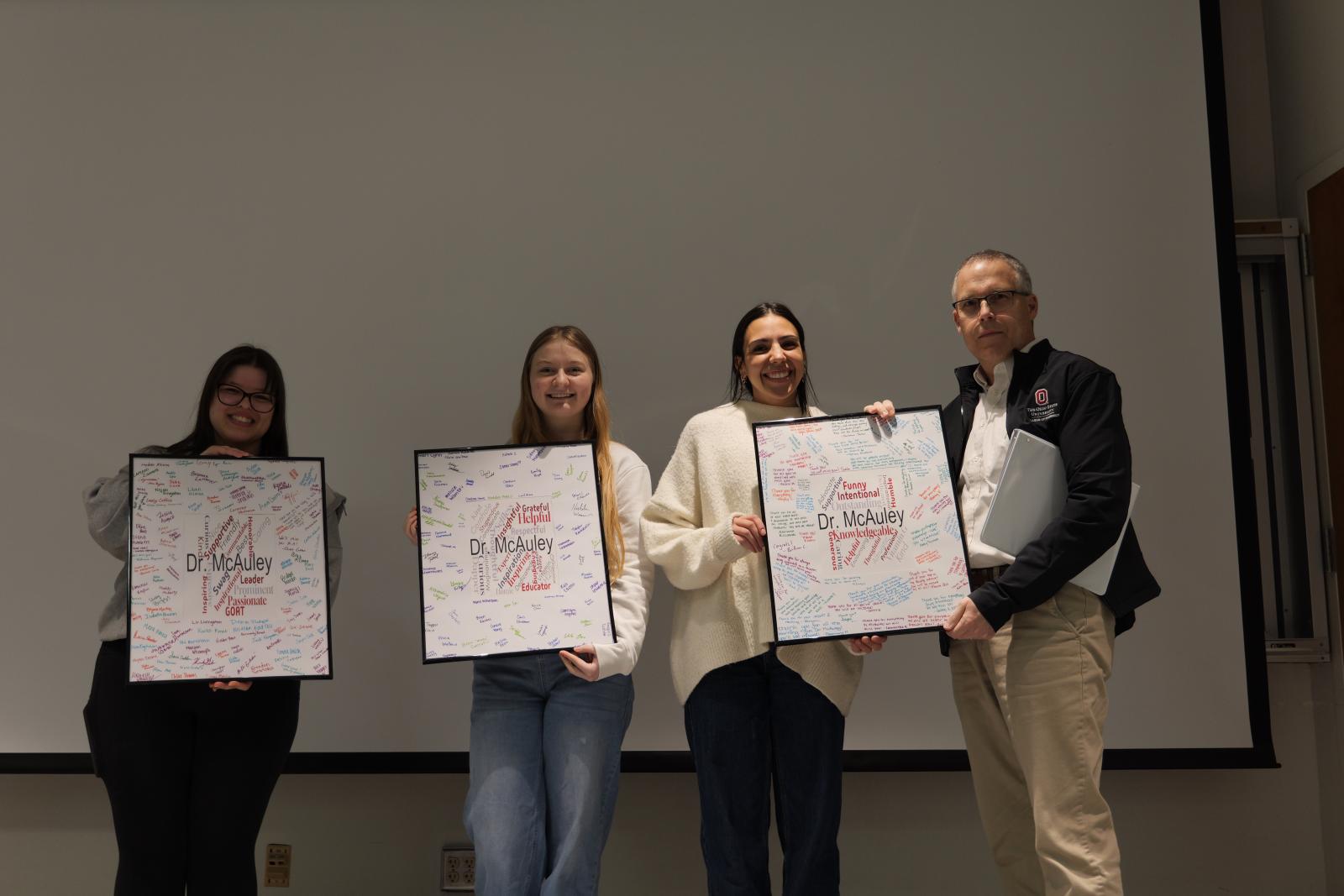 Students with Dr. McAuley and his name art