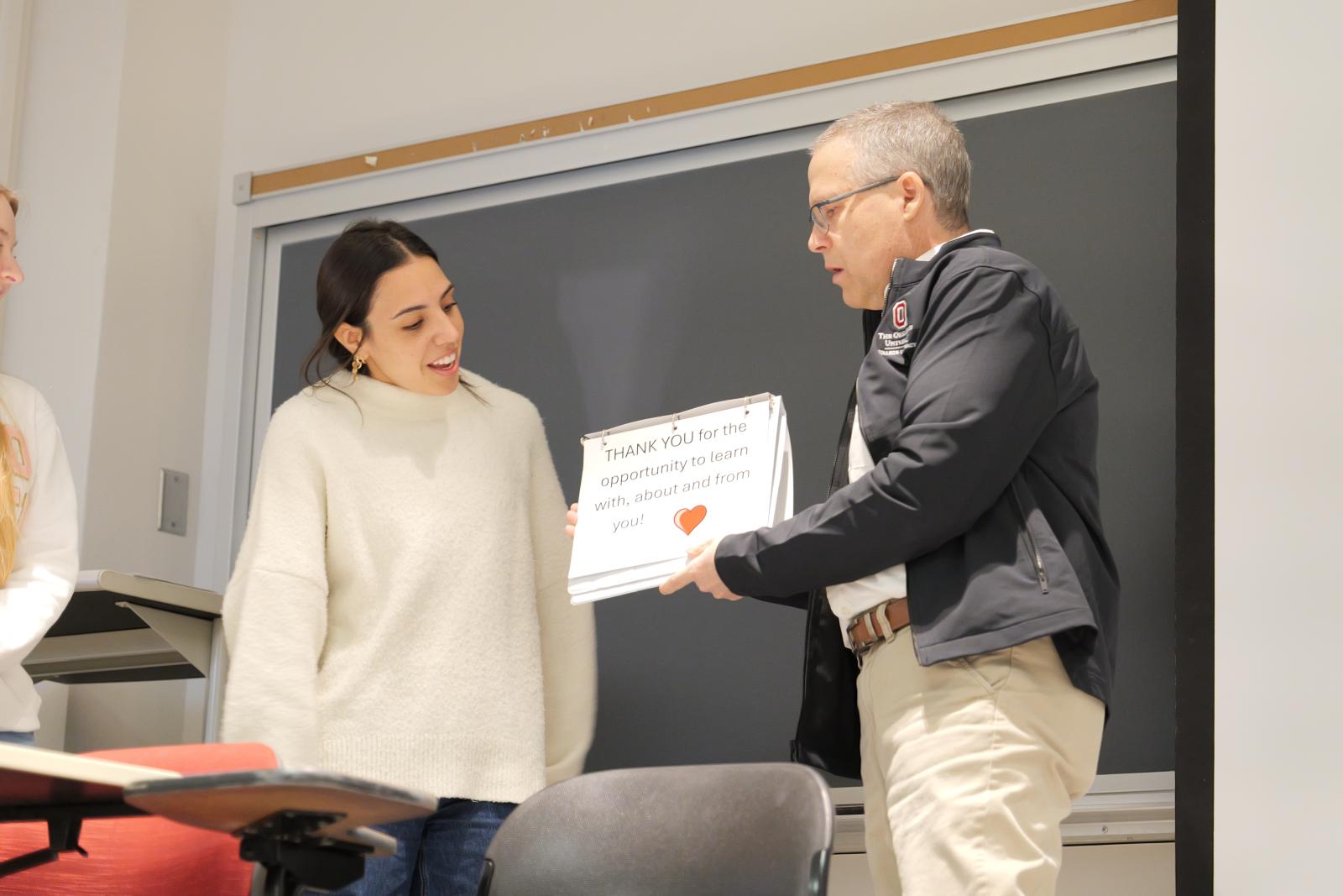 Dr. McAuley holding his speech sign