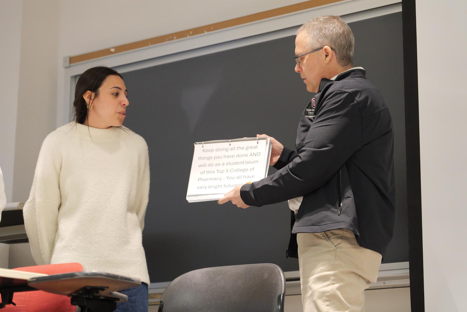 Dr. McAuley holding his speech sign
