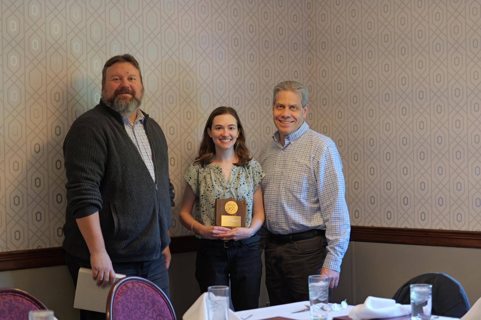 Dr. Fuchs, Lillian Cool holding a plaque and Dr. Peterson 