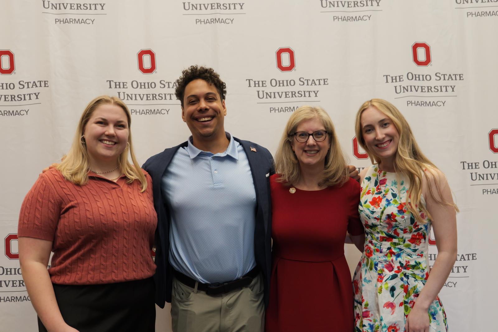 Four guests smiling