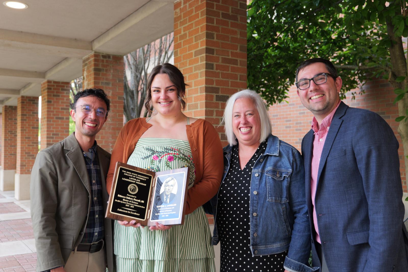 Preceptor, awardee, and two others smiling