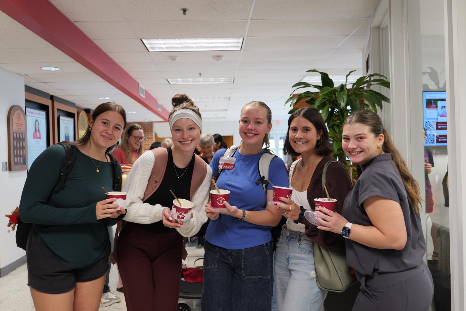 Students smiling holding their ice cream 