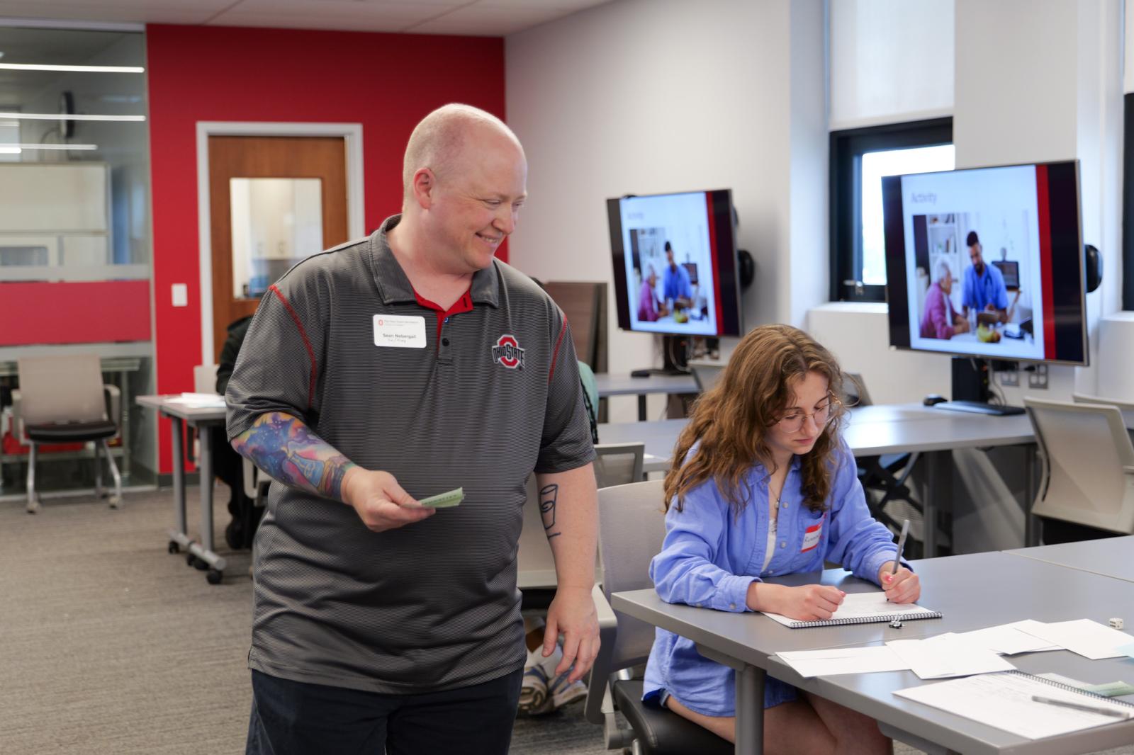 Instructor smiling at working student